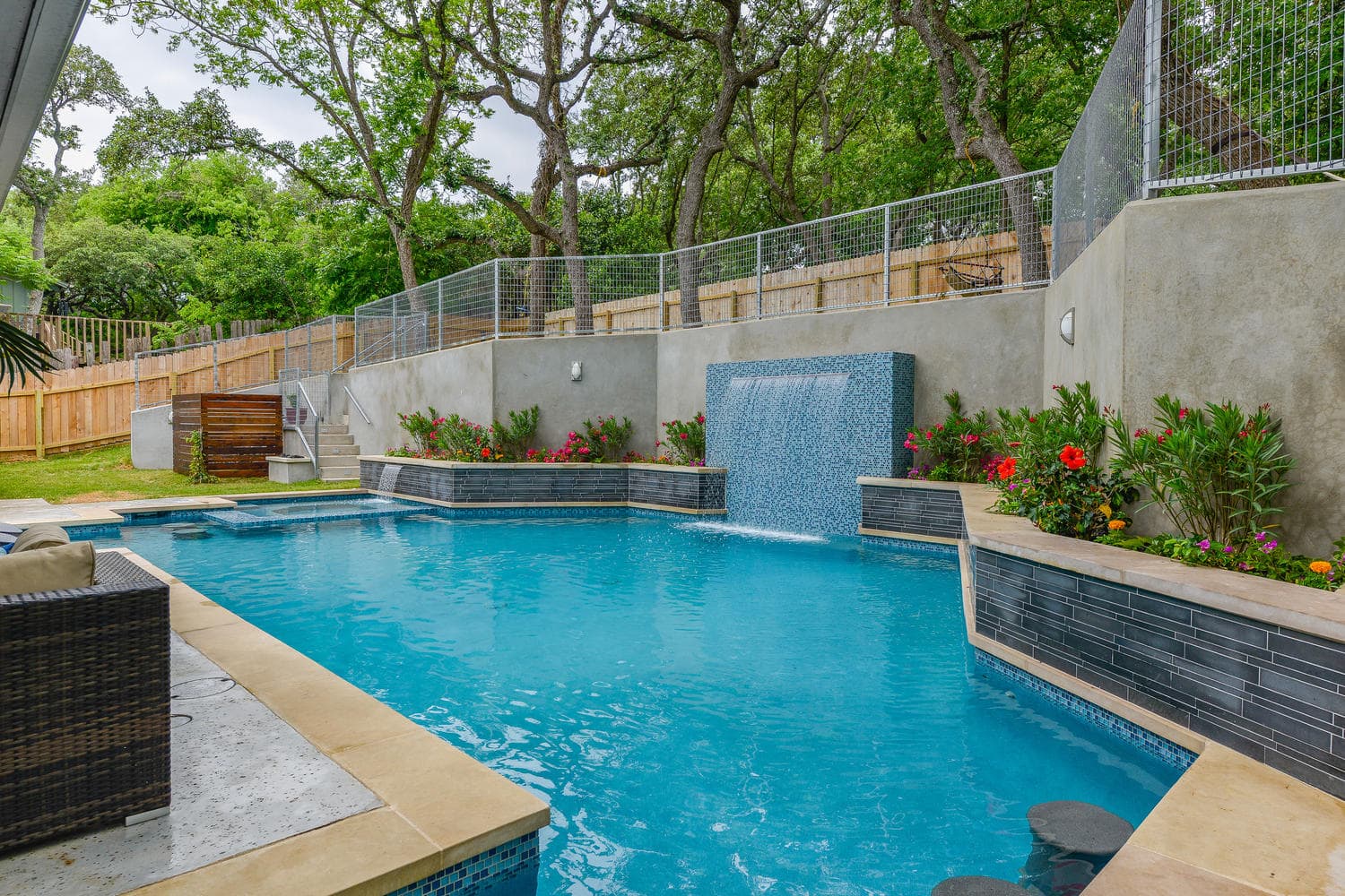 Norstone Lynia Interlocking Natural Stone Tile Ash Grey Basalt color used in pool raised beam feature wall in Texas